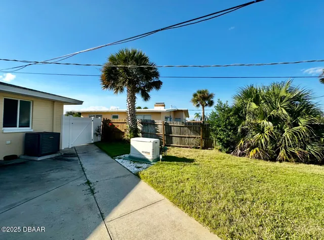 a view of a backyard with plants and a patio