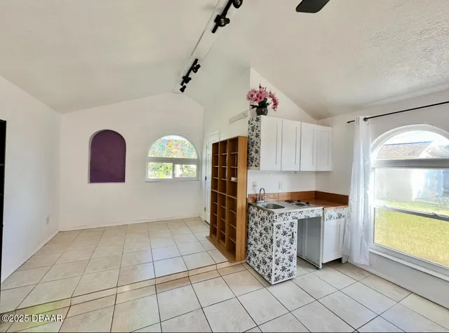 a kitchen with granite countertop a stove a sink and a refrigerator