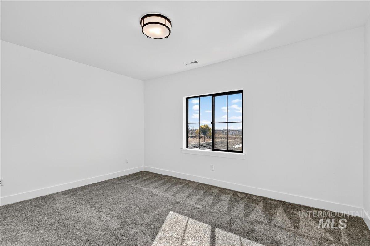 7714 West Flathead Lake Street, Unit ASPEN Eagle, ID 83616 - Photo 23 of 30 Empty room with carpet and baseboards