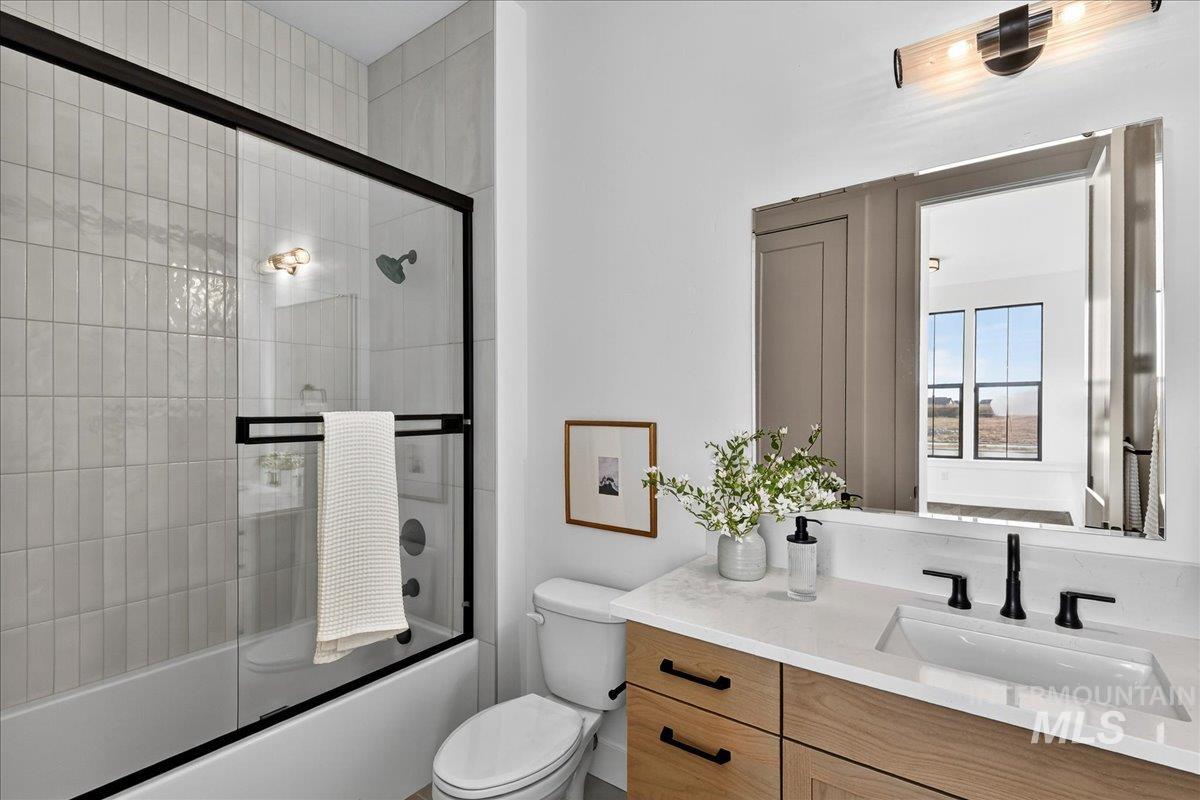 7714 West Flathead Lake Street, Unit ASPEN Eagle, ID 83616 - Photo 24 of 30 Bathroom featuring shower / bath combination with glass door and vanity