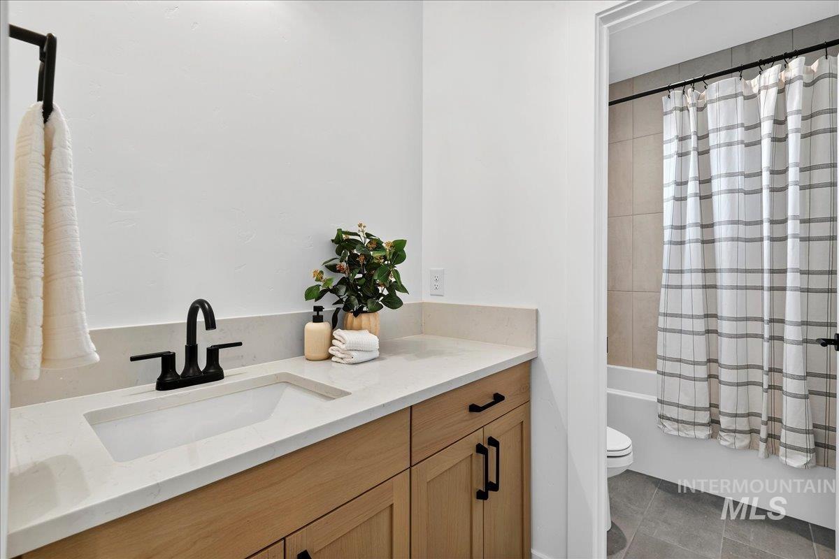7714 West Flathead Lake Street, Unit ASPEN Eagle, ID 83616 - Photo 25 of 30 Full bathroom with vanity, shower / bath combo, and tile patterned flooring