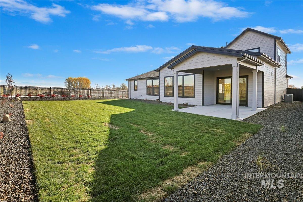 7714 West Flathead Lake Street, Unit ASPEN Eagle, ID 83616 - Photo 30 of 30 Rear view of house with a fenced backyard and a patio area