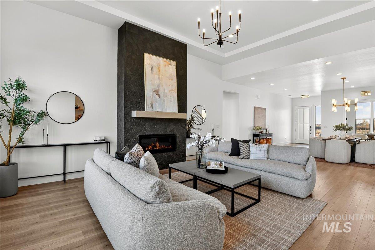 7714 West Flathead Lake Street, Unit ASPEN Eagle, ID 83616 - Photo 8 of 30 Living area with a chandelier, light wood-type flooring, a high end fireplace, and recessed lighting