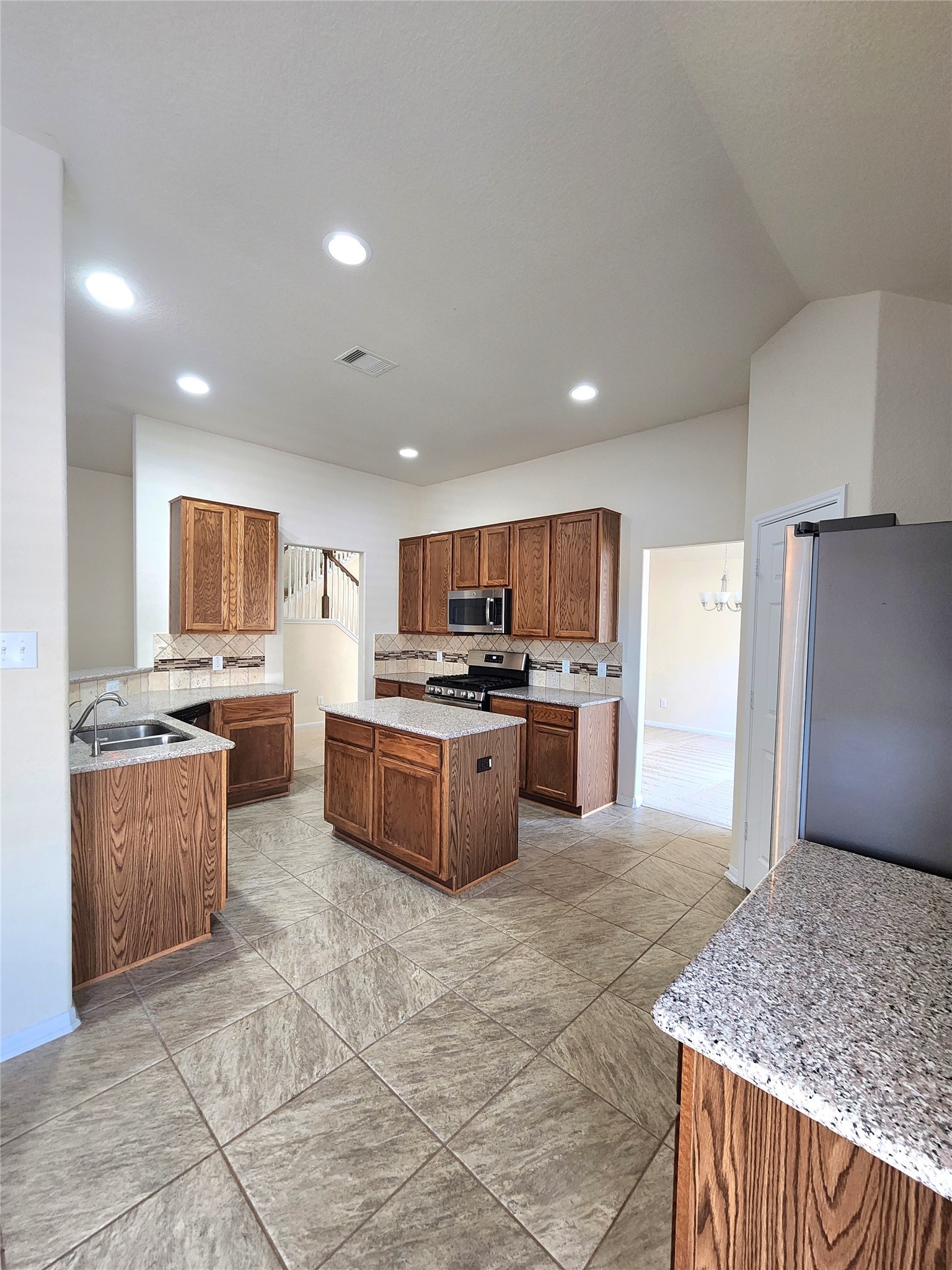 5427 Seabird Street Baytown, TX 77521 - Photo 5 of 34 The spacious 18'x15', centrally located kitchen is the hub of the house! Refrigerator, gas stove, built-in microwave and dishwasher... all included!