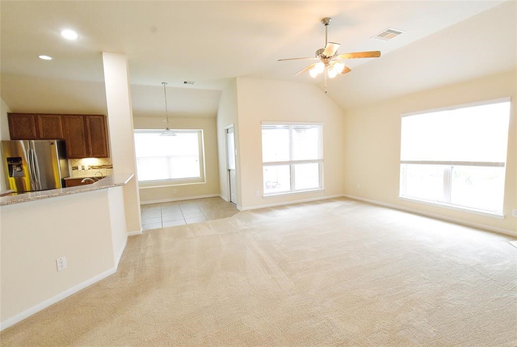 5427 Seabird Street Baytown, TX 77521 - Photo 9 of 34 Living room open to kitchen and breakfast areas. Large breakfast bar
