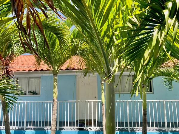 front view of a house with a tree