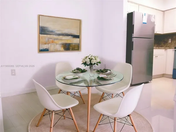 a dining room with furniture and window