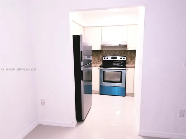 a kitchen with a stove and a refrigerator