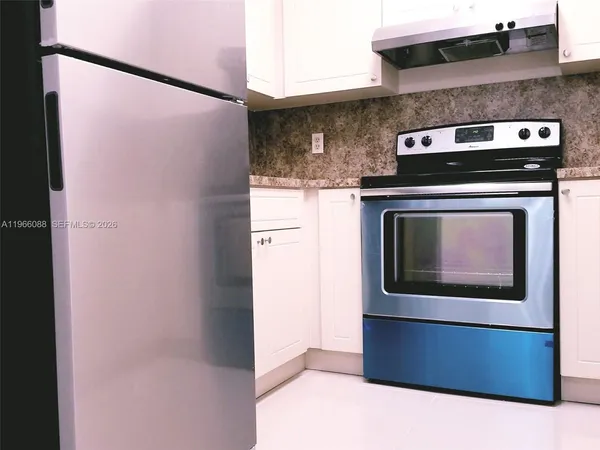 a stove top oven sitting inside of a kitchen