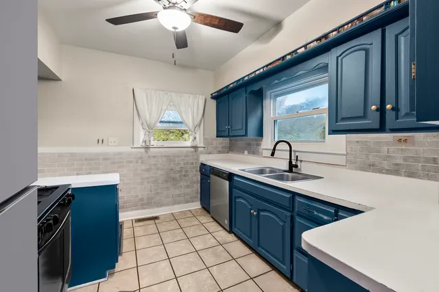 a kitchen with a sink appliances and cabinets