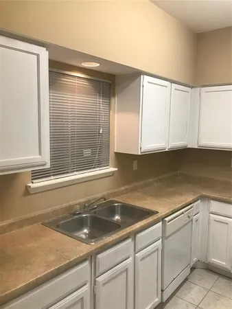 a kitchen with a sink and cabinets