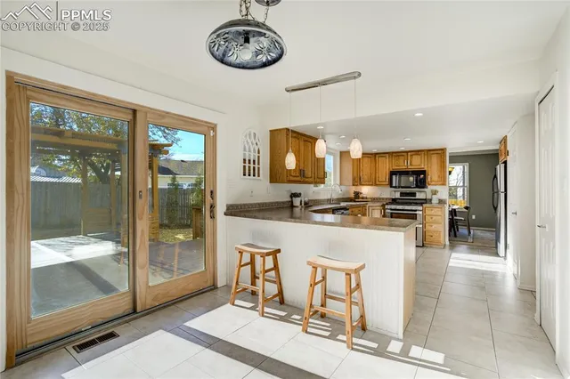a large open kitchen with a large window and stainless steel appliances