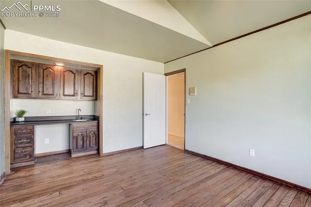 a view of kitchen with granite countertop cabinets and wooden floor