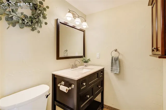 a bathroom with a sink vanity and a mirror