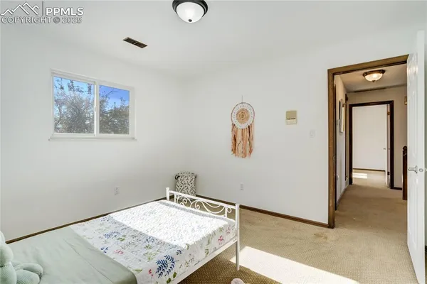 a view of a bedroom with a bed and hallway