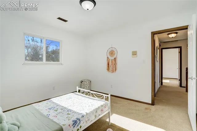 a view of a bedroom with a bed and hallway