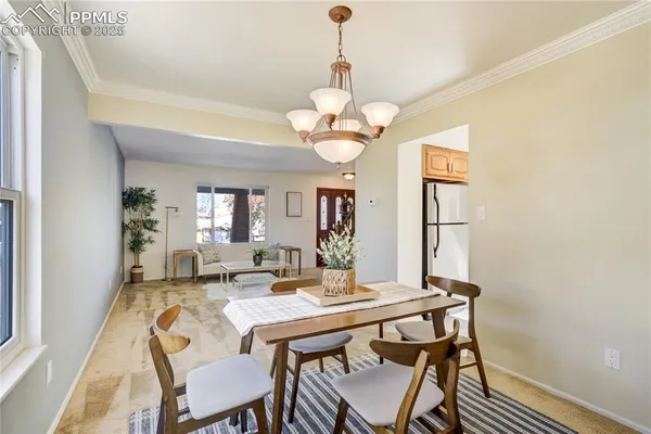 a view of a dining room with a table and chairs