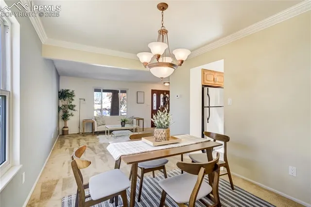 a view of a dining room with a table and chairs
