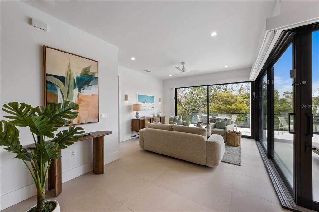 7003 Holmes Boulevard Holmes Beach, FL 34217 - Photo 19 of 70 a living room with furniture and a potted plant
