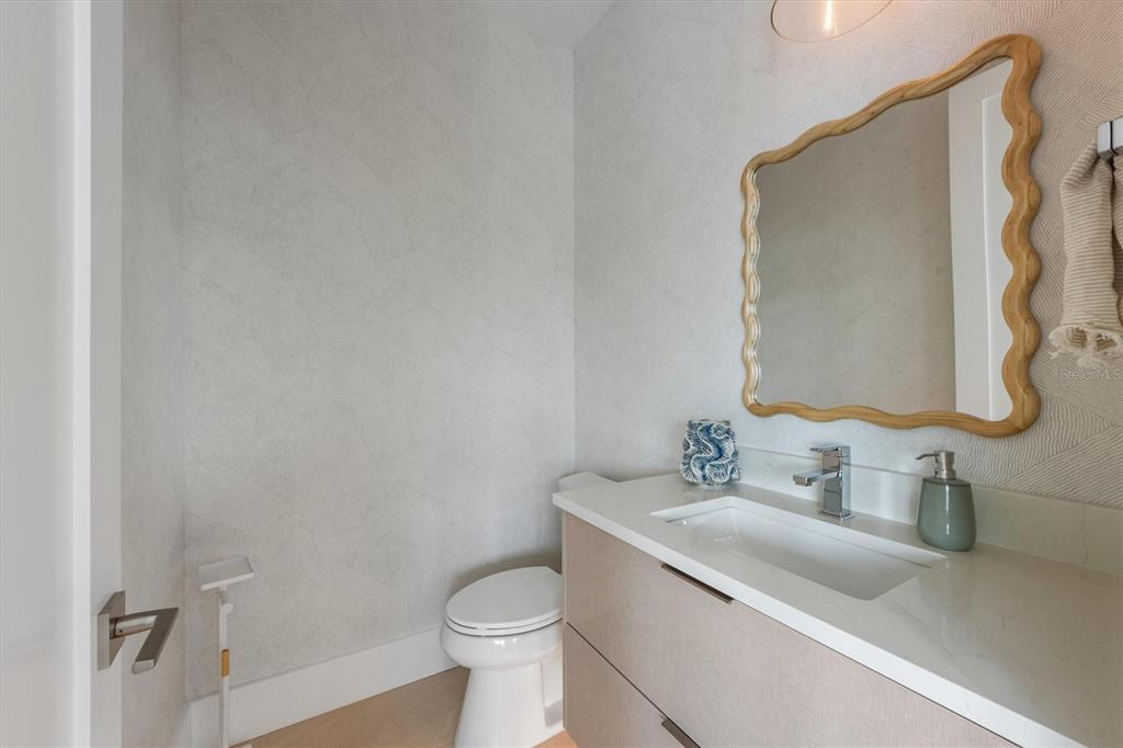 7003 Holmes Boulevard Holmes Beach, FL 34217 - Photo 24 of 70 a bathroom with a sink toilet and vanity