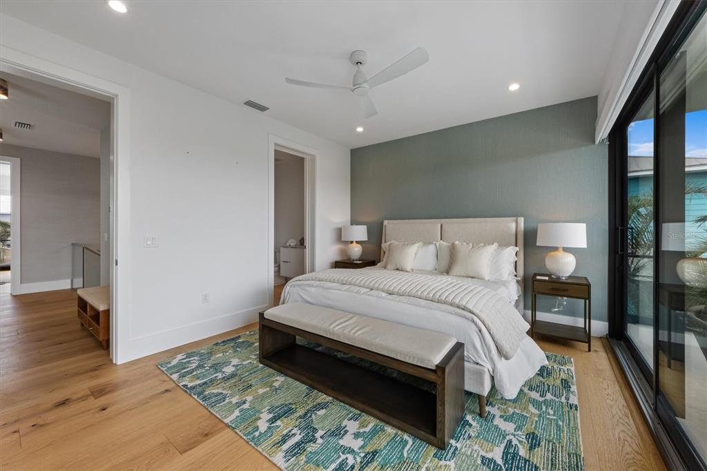 7003 Holmes Boulevard Holmes Beach, FL 34217 - Photo 30 of 70 a bedroom with a bed lamp closet and a large window