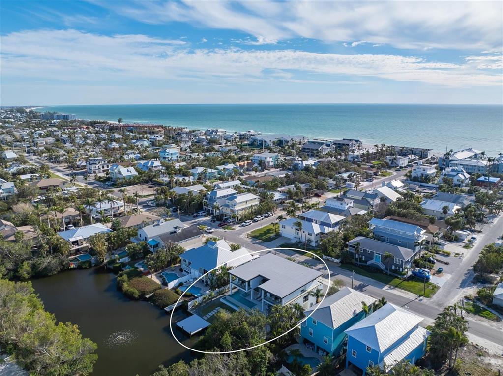 7003 Holmes Boulevard Holmes Beach, FL 34217 - Photo 5 of 70 an aerial view of a residential houses with outdoor space and ocean view