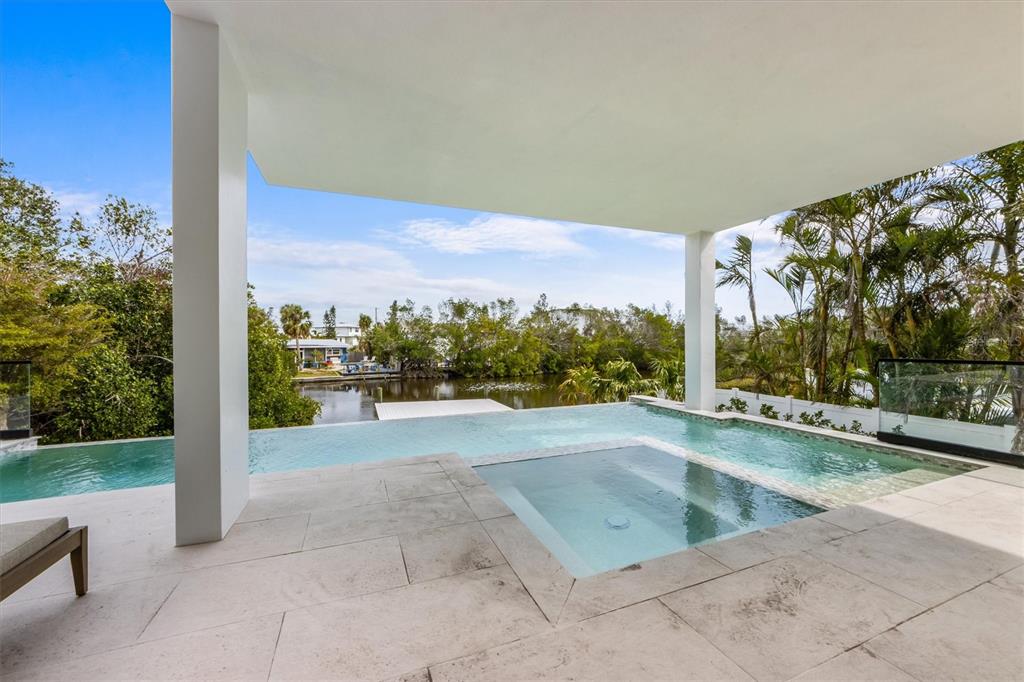 7003 Holmes Boulevard Holmes Beach, FL 34217 - Photo 54 of 70 a view of a swimming pool and outdoor space