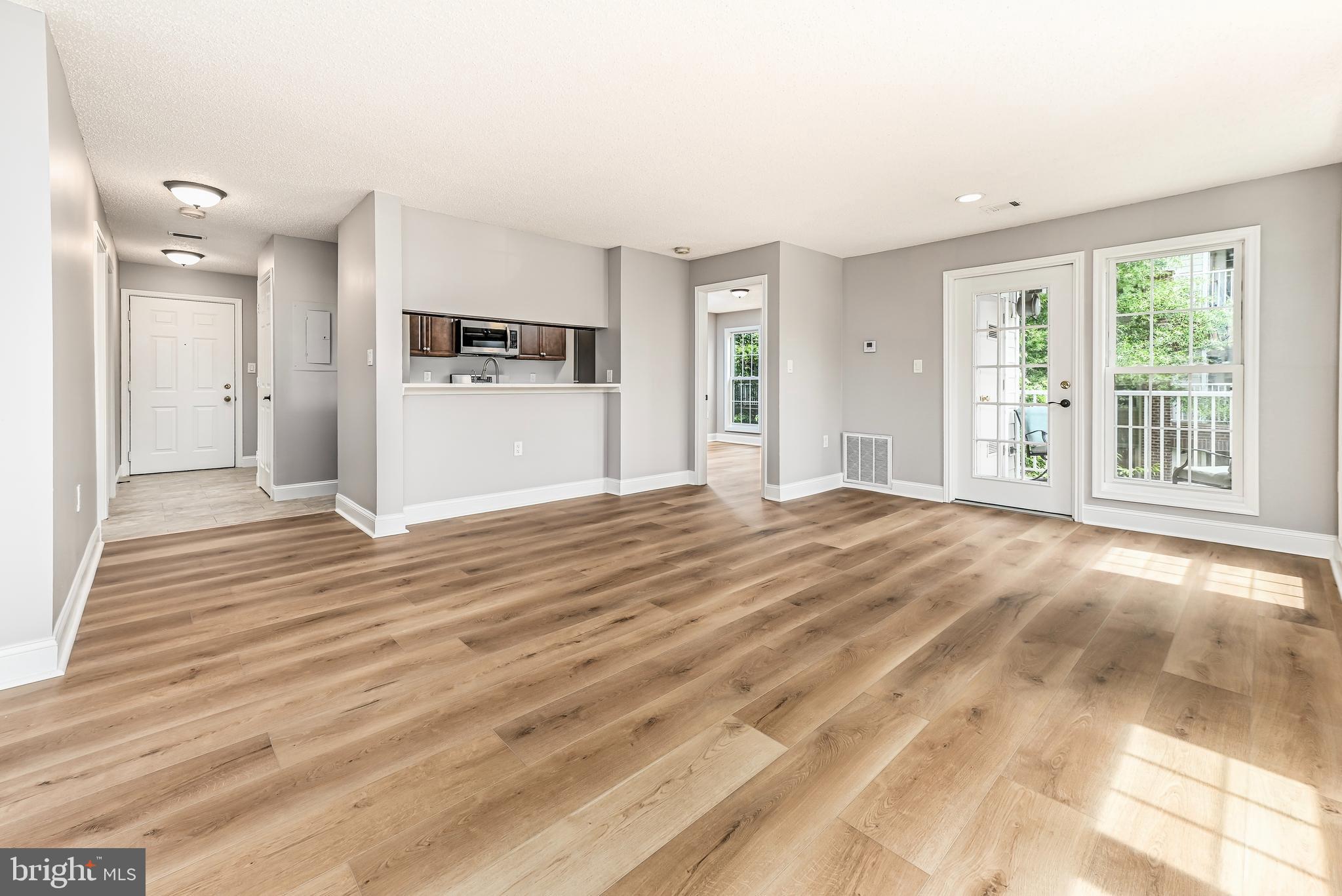 20991 Timber Ridge Terrace, Unit 204 Ashburn, VA 20147 - Photo 4 of 27 Living Room/Dining Room