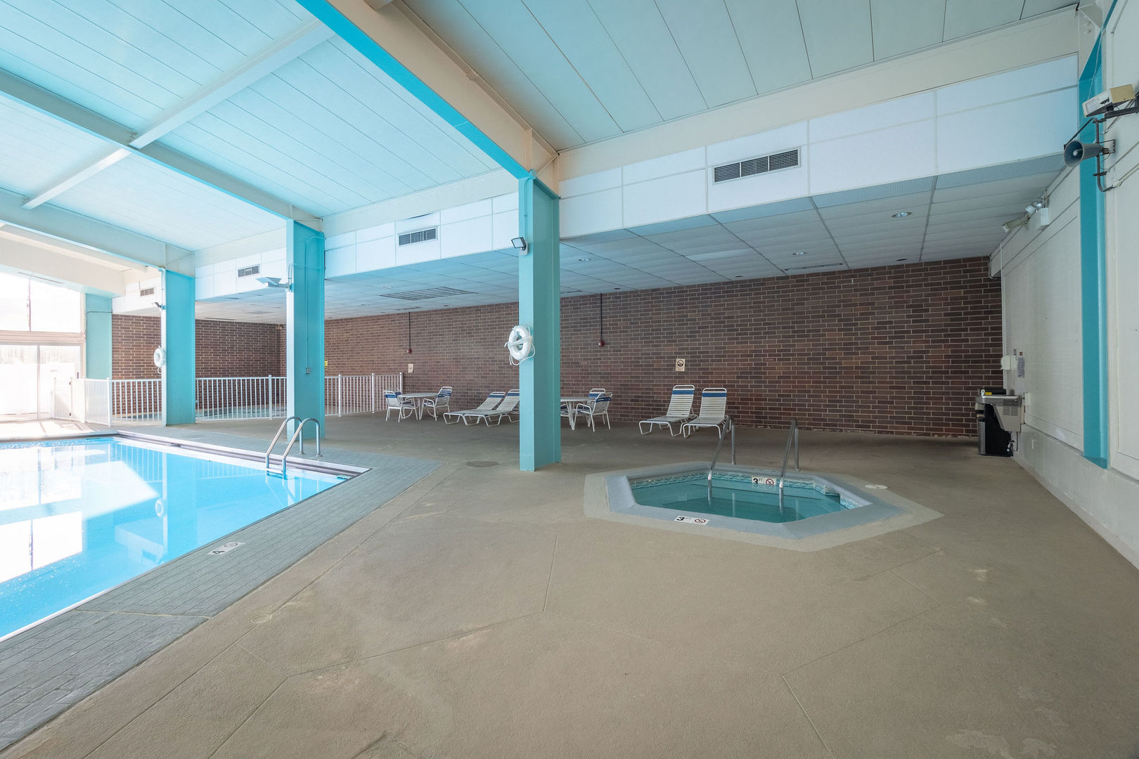 701 Forum Square, Unit 506 Glenview, IL 60025 - Photo 12 of 13 a view of a hallway with a table and chairs