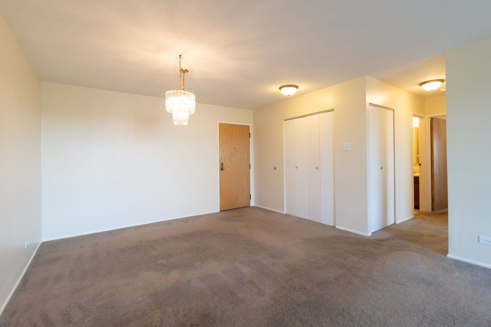 701 Forum Square, Unit 506 Glenview, IL 60025 - Photo 3 of 13 a view of a chandelier in big room and a bathroom