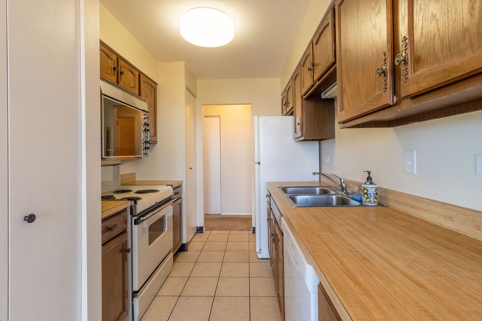 701 Forum Square, Unit 506 Glenview, IL 60025 - Photo 7 of 13 a kitchen with stainless steel appliances granite countertop a stove and a sink