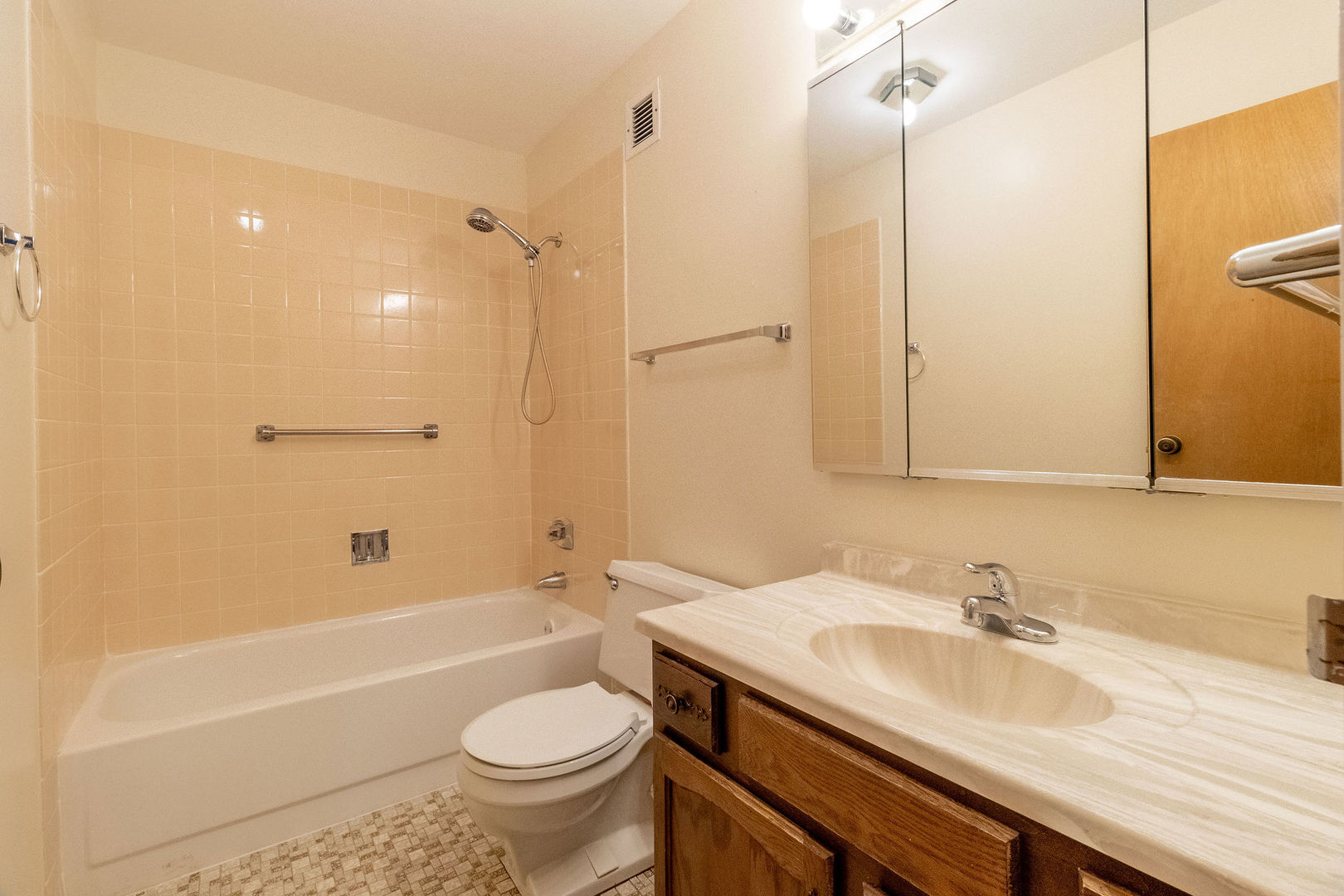 701 Forum Square, Unit 506 Glenview, IL 60025 - Photo 8 of 13 a bathroom with a granite countertop sink a toilet a mirror and bathtub