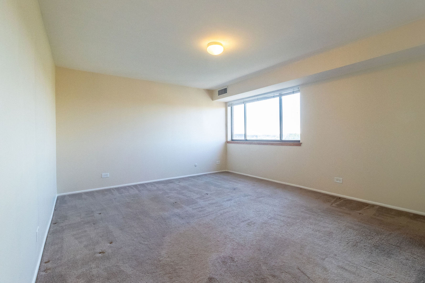 701 Forum Square, Unit 506 Glenview, IL 60025 - Photo 9 of 13 an empty room with windows