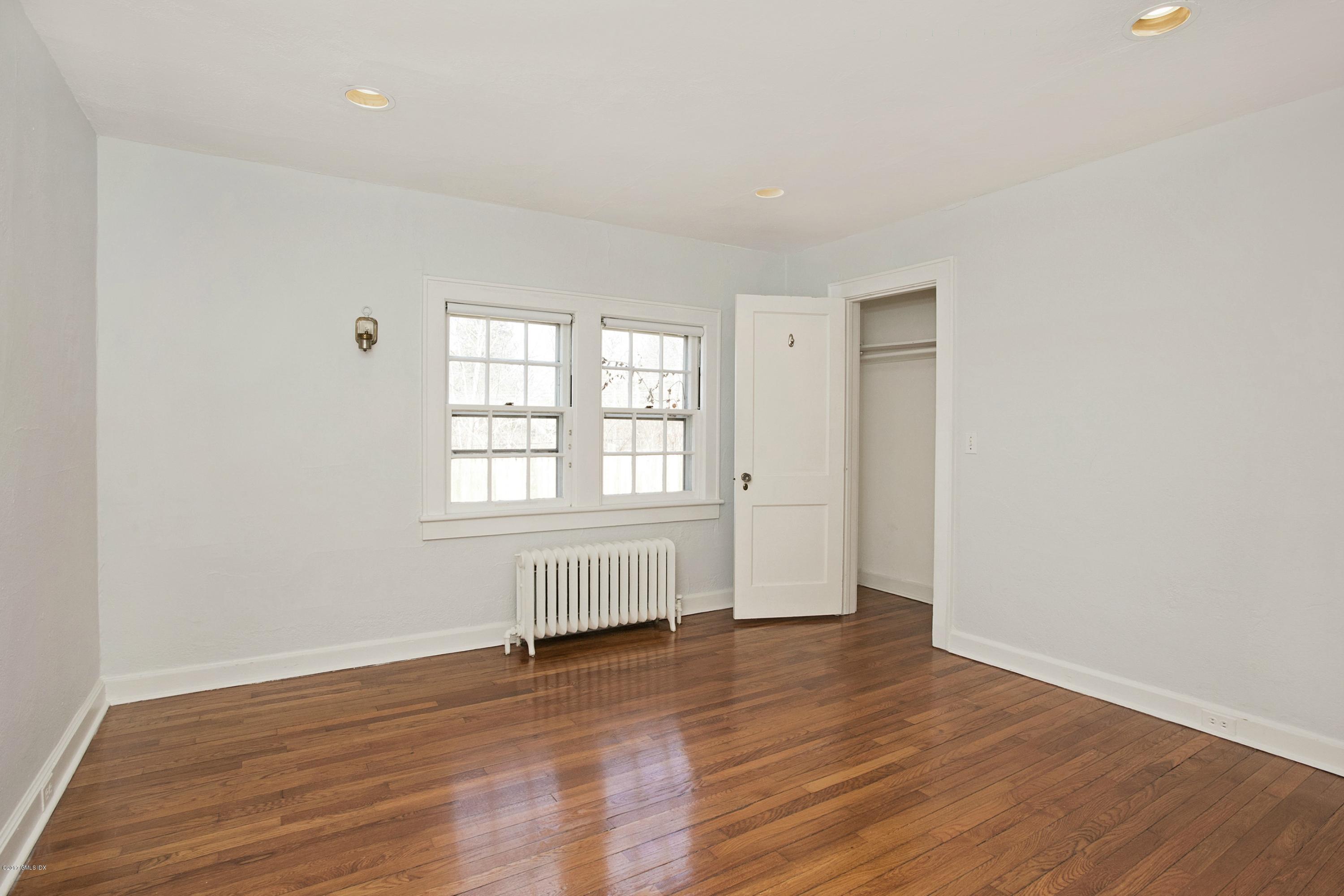 55 Oval Avenue Riverside, CT 06878 - Photo 11 of 19 an empty room with wooden floor and windows