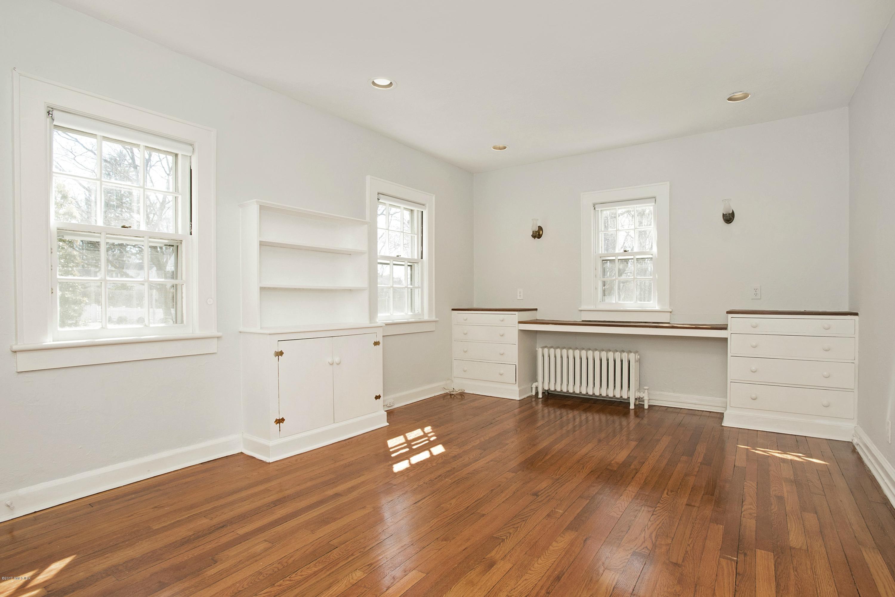 55 Oval Avenue Riverside, CT 06878 - Photo 12 of 19 an empty room with wooden floor and windows