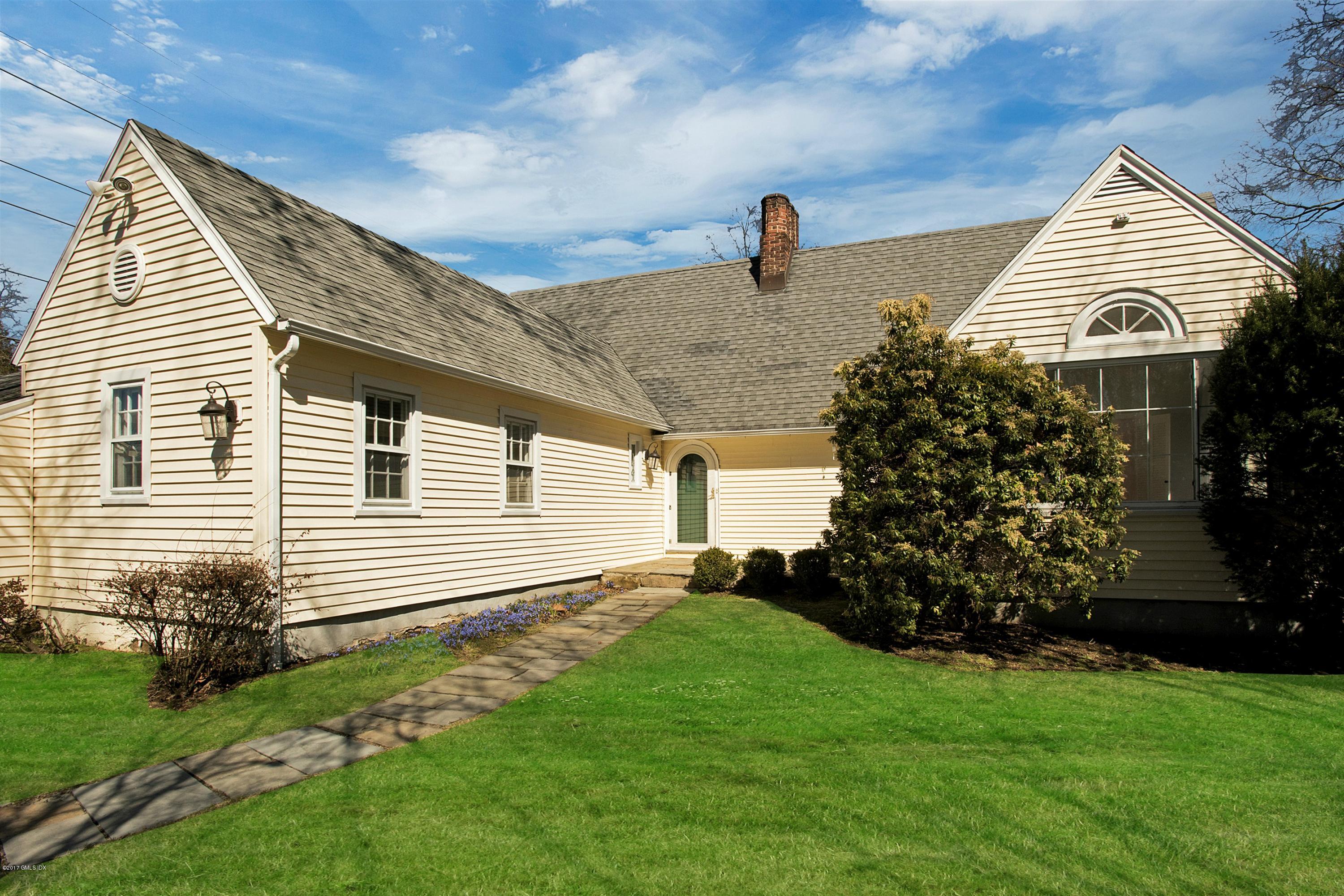 55 Oval Avenue Riverside, CT 06878 - Photo 16 of 19 a front view of a house with garden