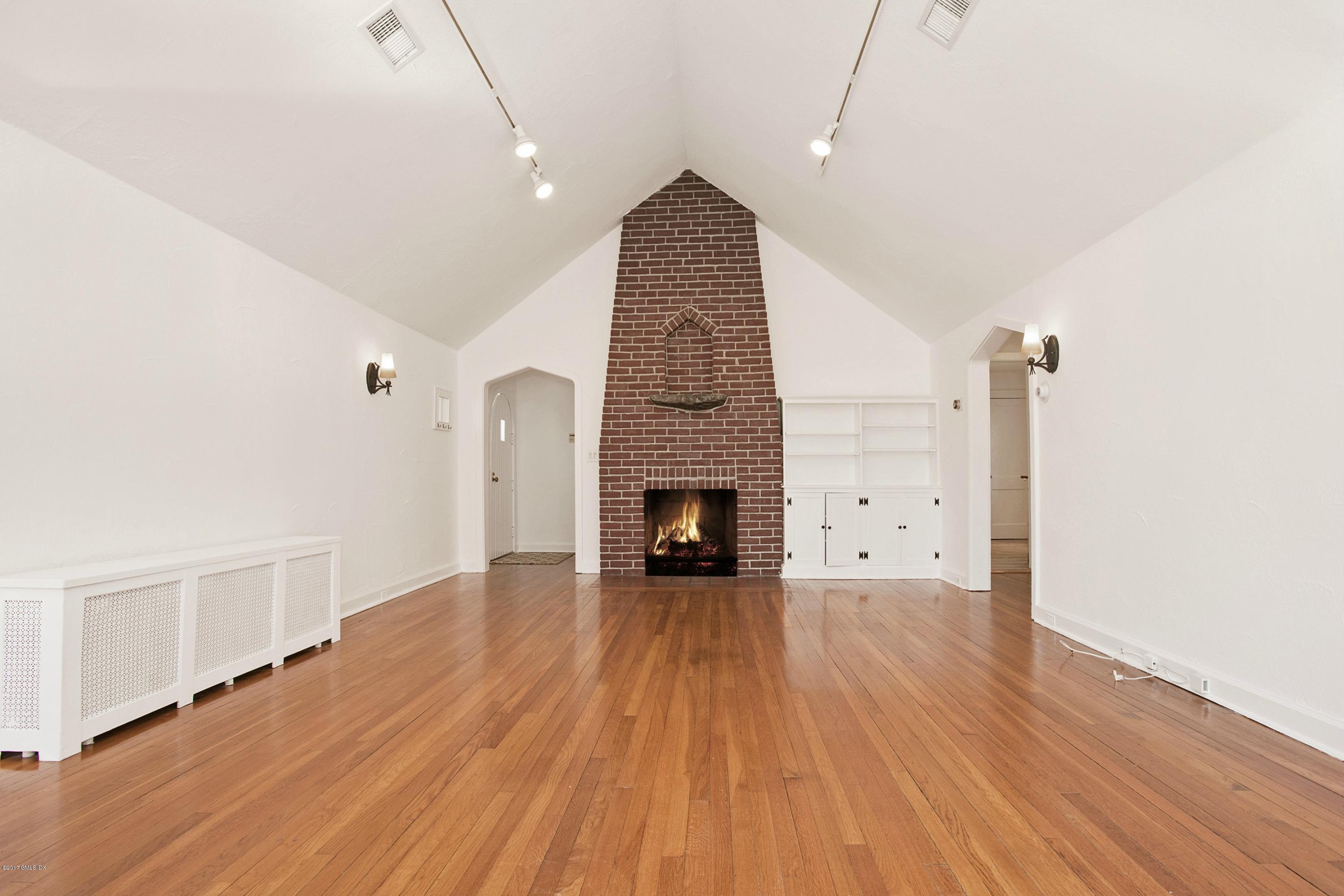 55 Oval Avenue Riverside, CT 06878 - Photo 3 of 19 an empty room with wooden floor and fireplace