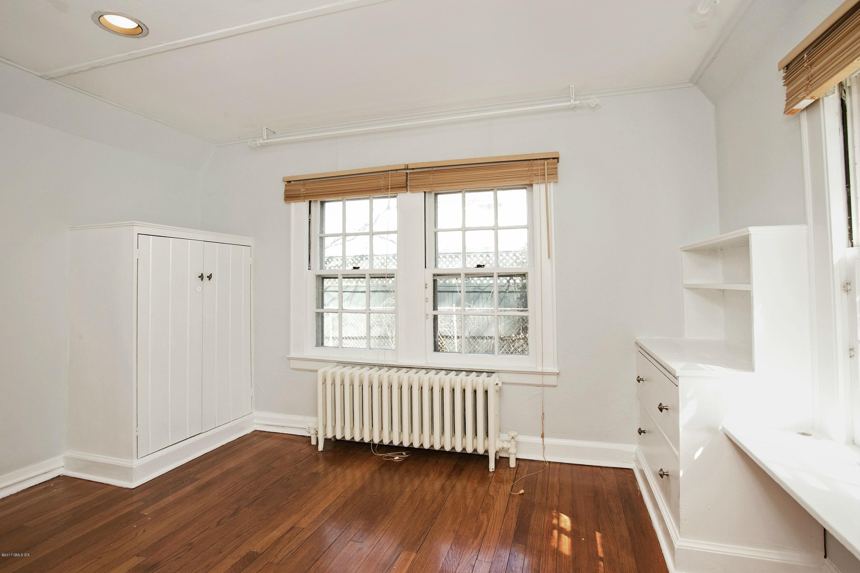 55 Oval Avenue Riverside, CT 06878 - Photo 5 of 19 a view of an empty room with wooden floor and a window
