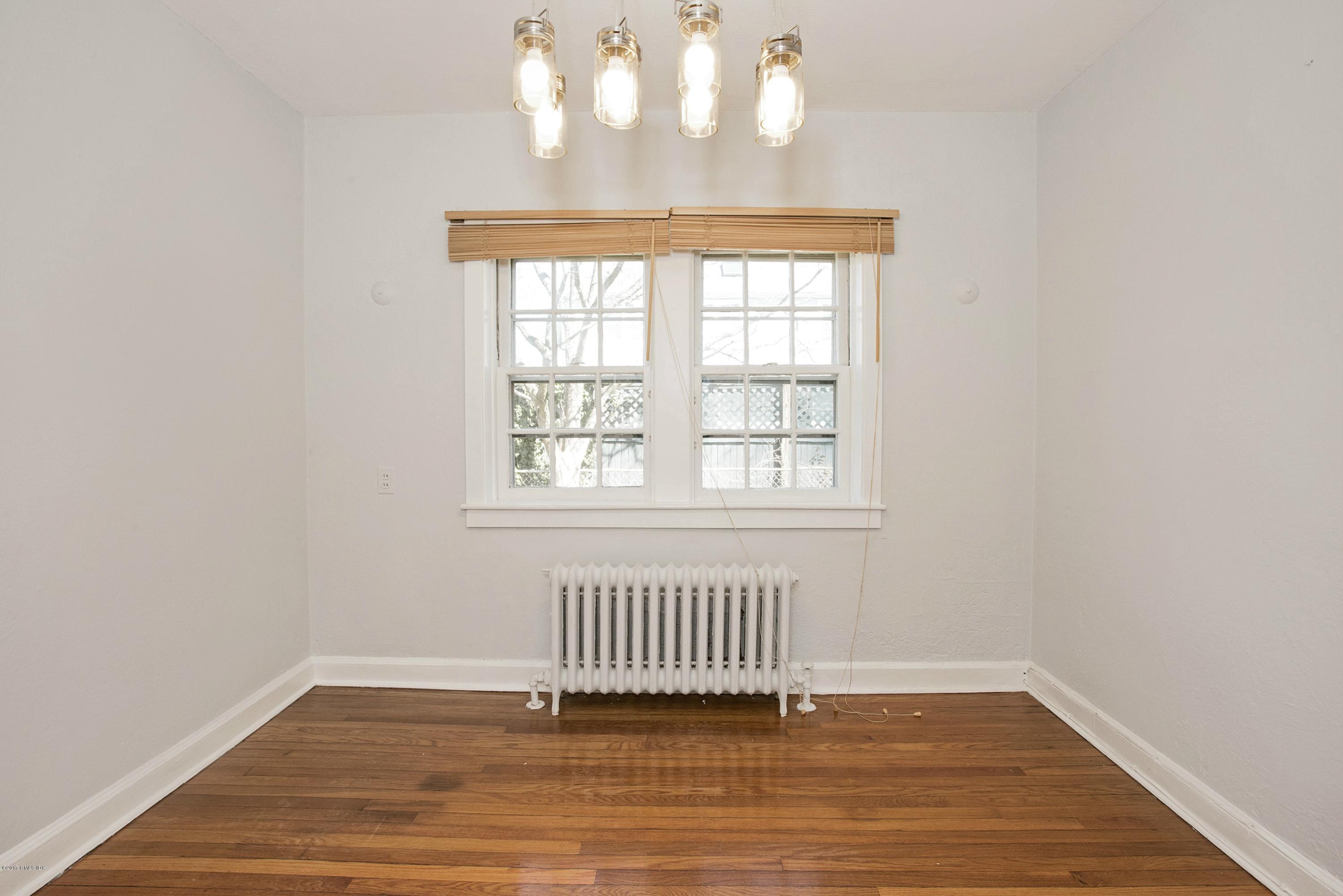 55 Oval Avenue Riverside, CT 06878 - Photo 6 of 19 an empty room with wooden floor and windows