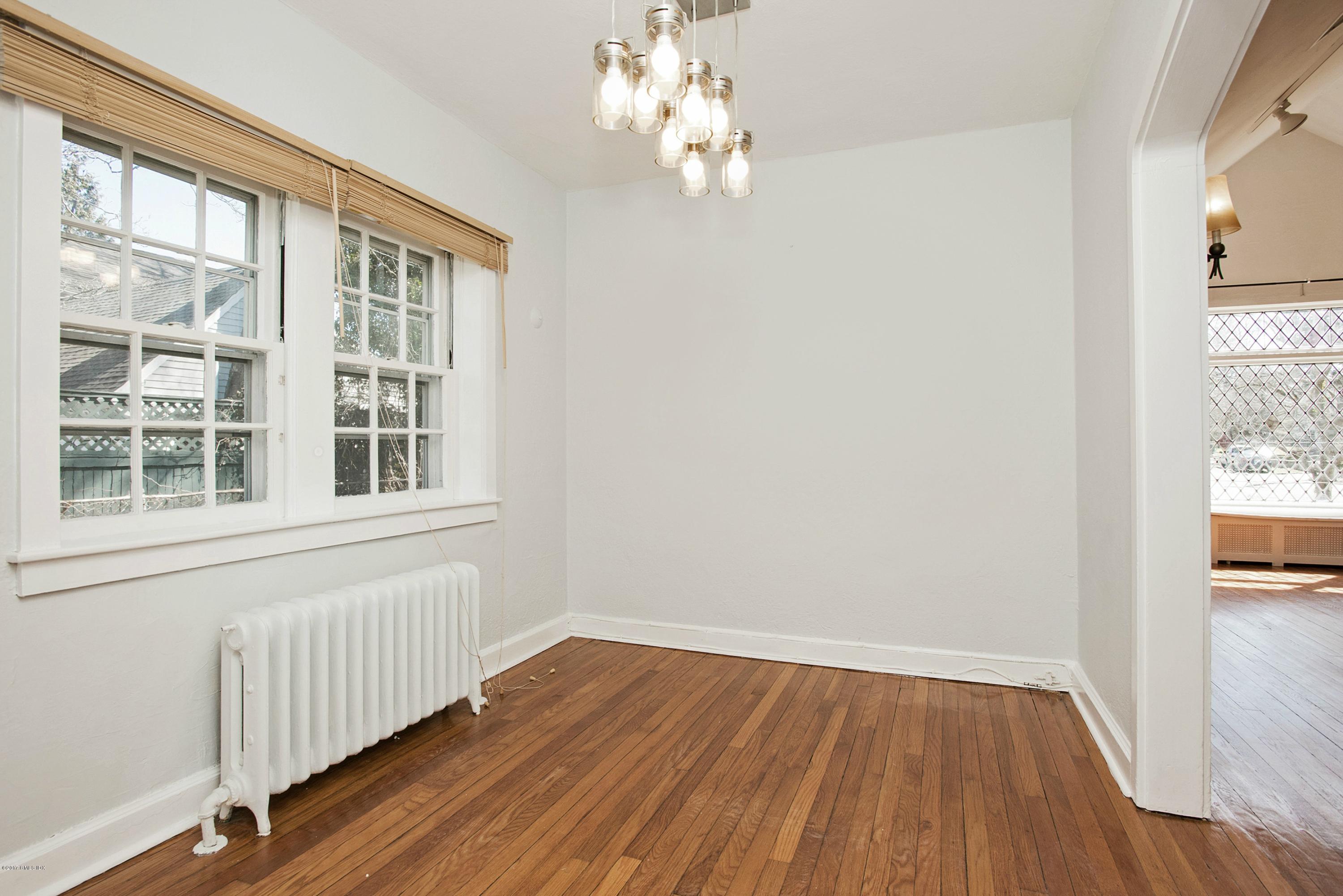 55 Oval Avenue Riverside, CT 06878 - Photo 7 of 19 a view of an empty room with wooden floor and a window