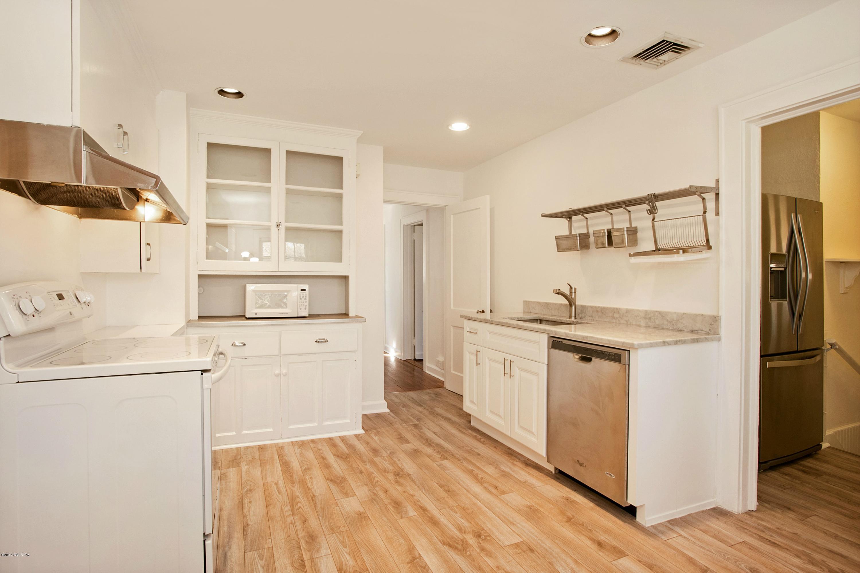 55 Oval Avenue Riverside, CT 06878 - Photo 8 of 19 a kitchen with a sink stove and refrigerator