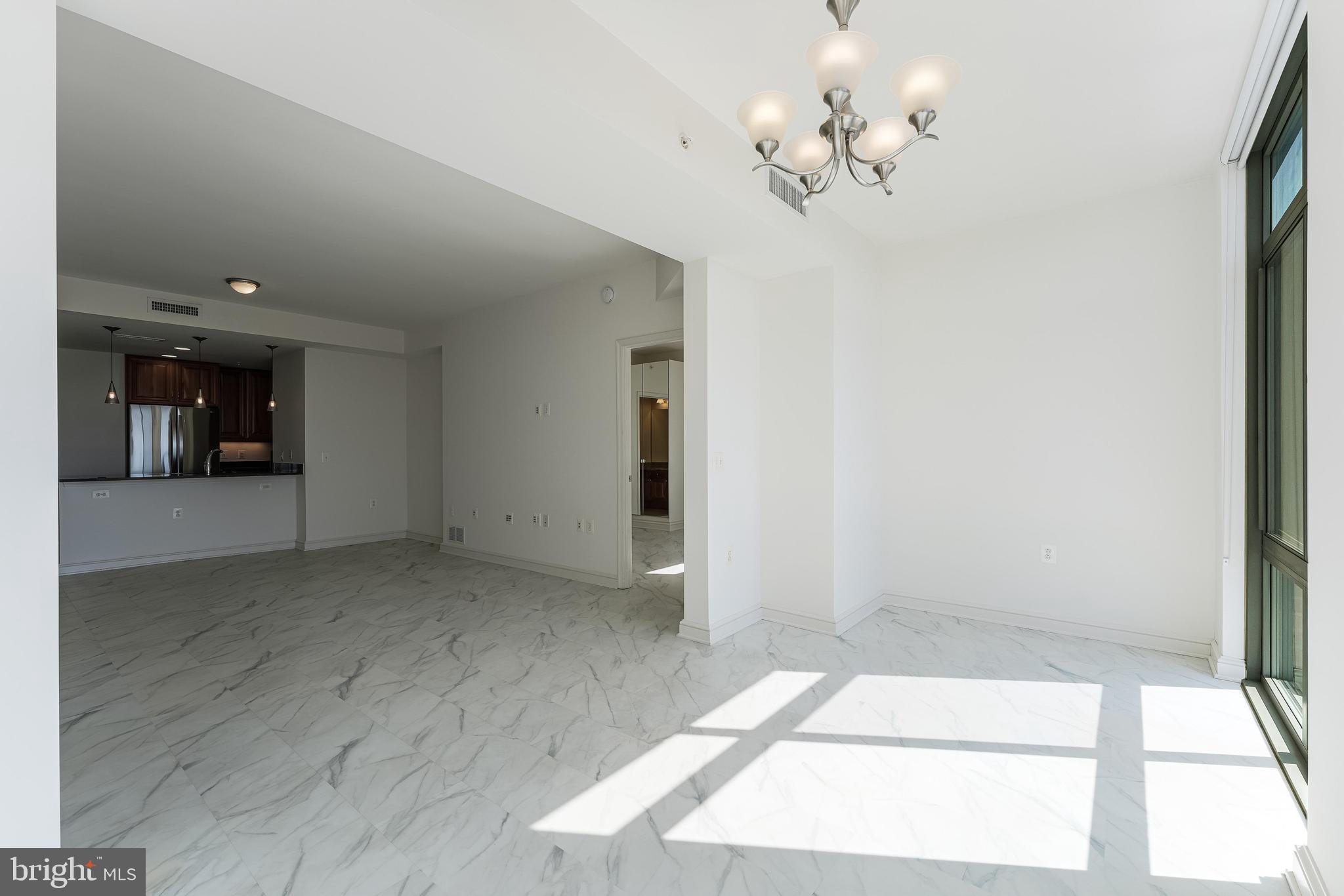 11990 Market Street, Unit 1414 Reston, VA 20190 - Photo 12 of 65 a view of a chandelier fan and fire place