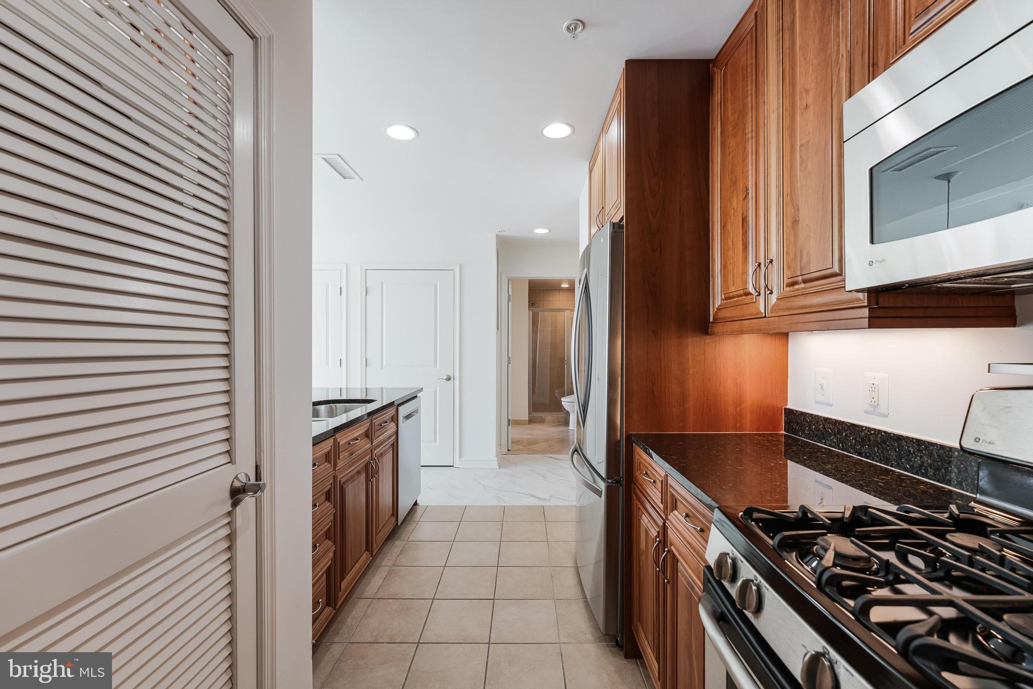 11990 Market Street, Unit 1414 Reston, VA 20190 - Photo 26 of 65 a kitchen with a stove and a sink