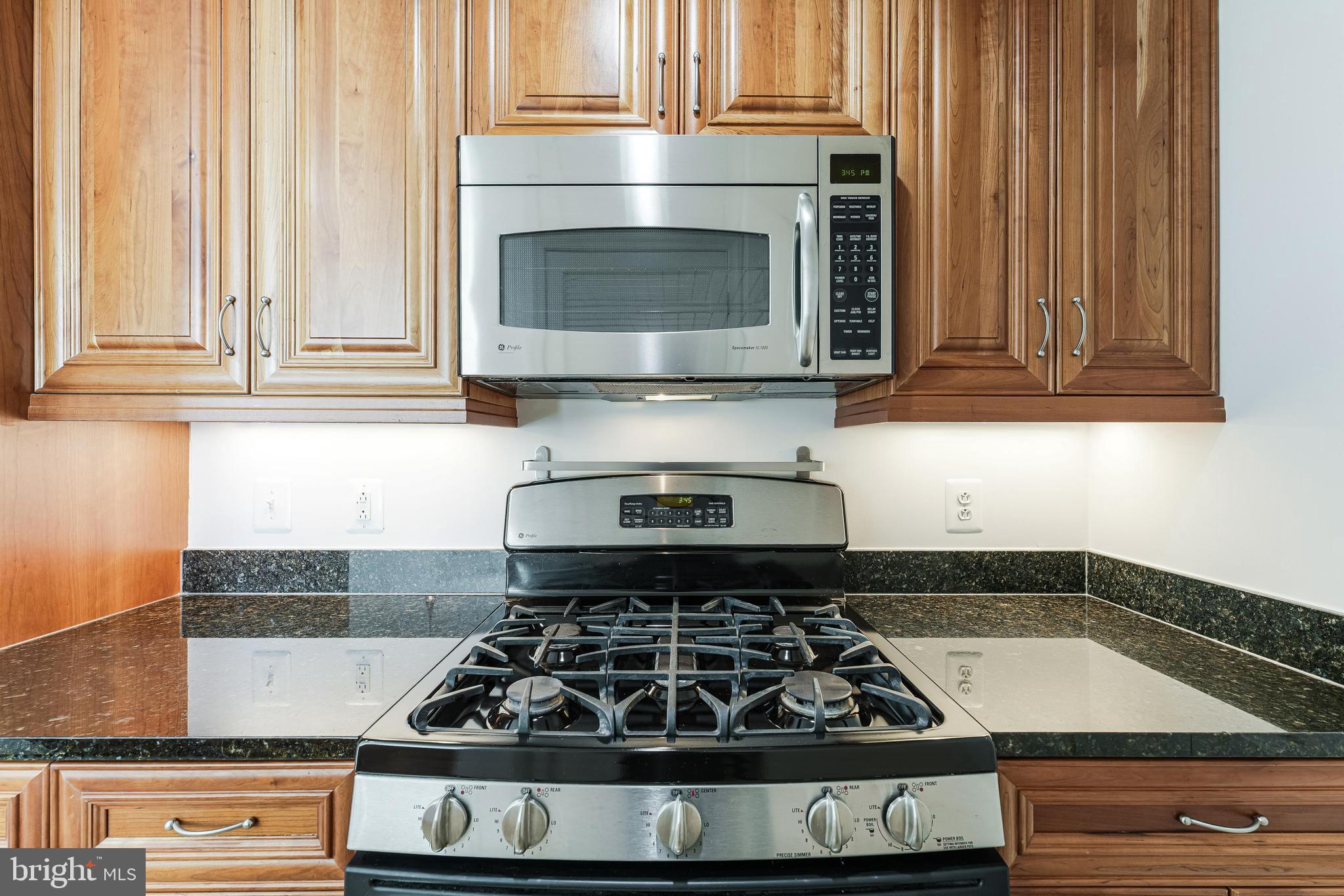 11990 Market Street, Unit 1414 Reston, VA 20190 - Photo 28 of 65 a kitchen with granite countertop stainless steel appliances stove and cabinets