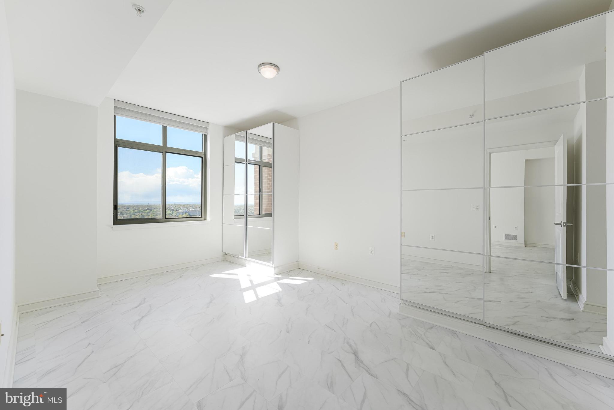 11990 Market Street, Unit 1414 Reston, VA 20190 - Photo 30 of 65 an empty room with windows and closet
