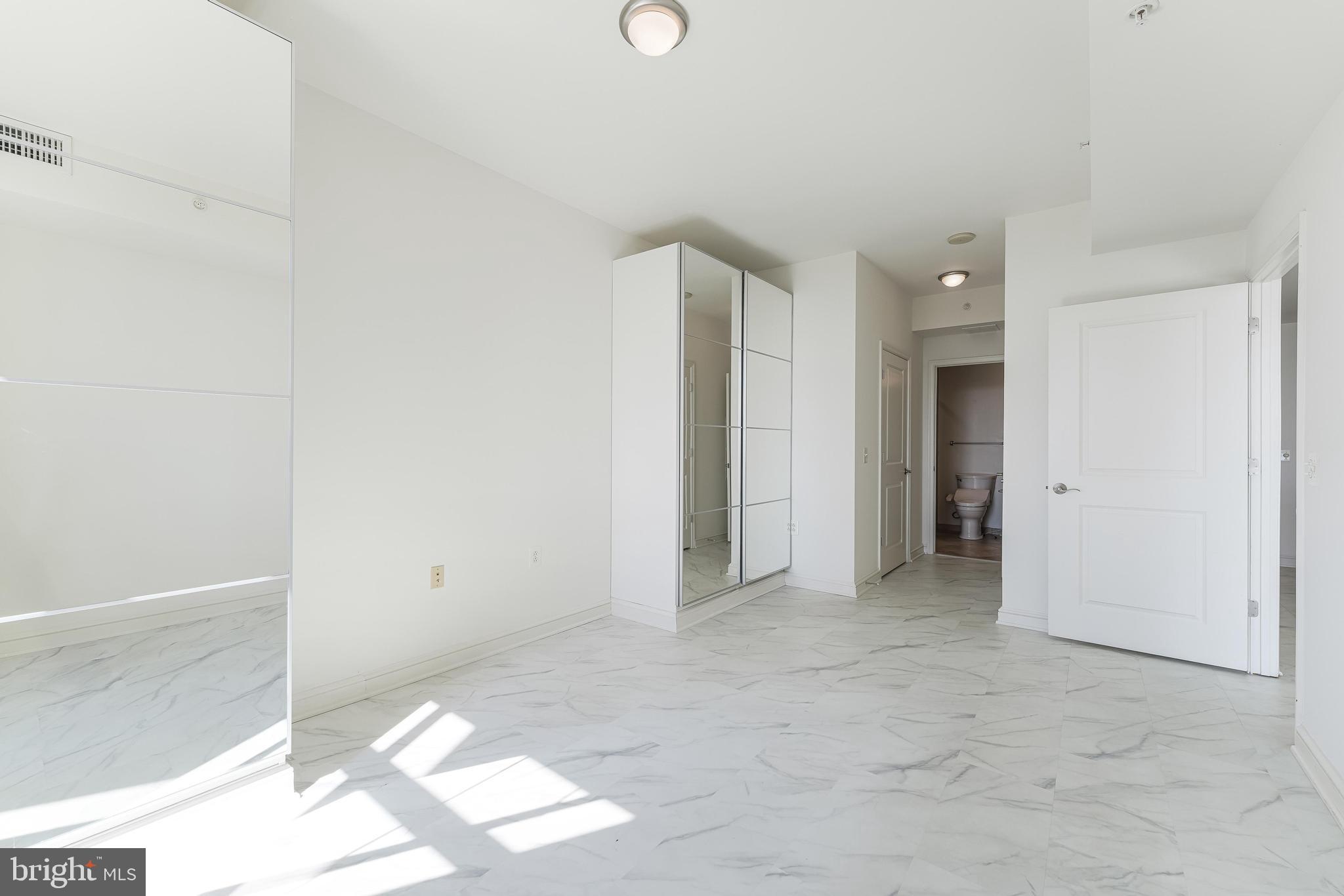 11990 Market Street, Unit 1414 Reston, VA 20190 - Photo 32 of 65 an empty room with windows