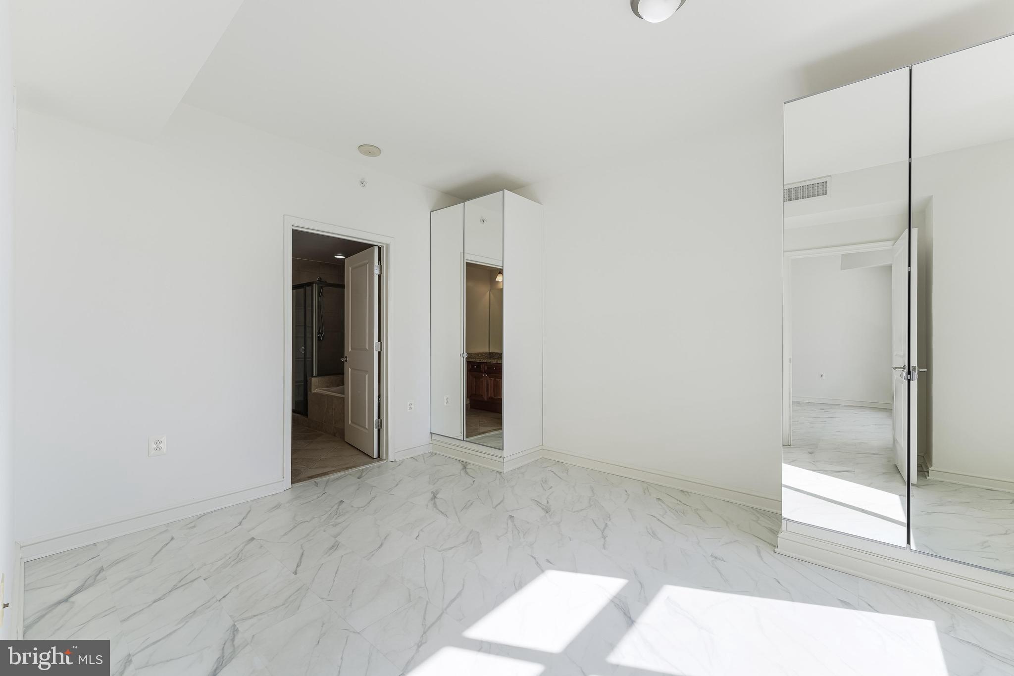 11990 Market Street, Unit 1414 Reston, VA 20190 - Photo 37 of 65 a view of an empty room with glass door