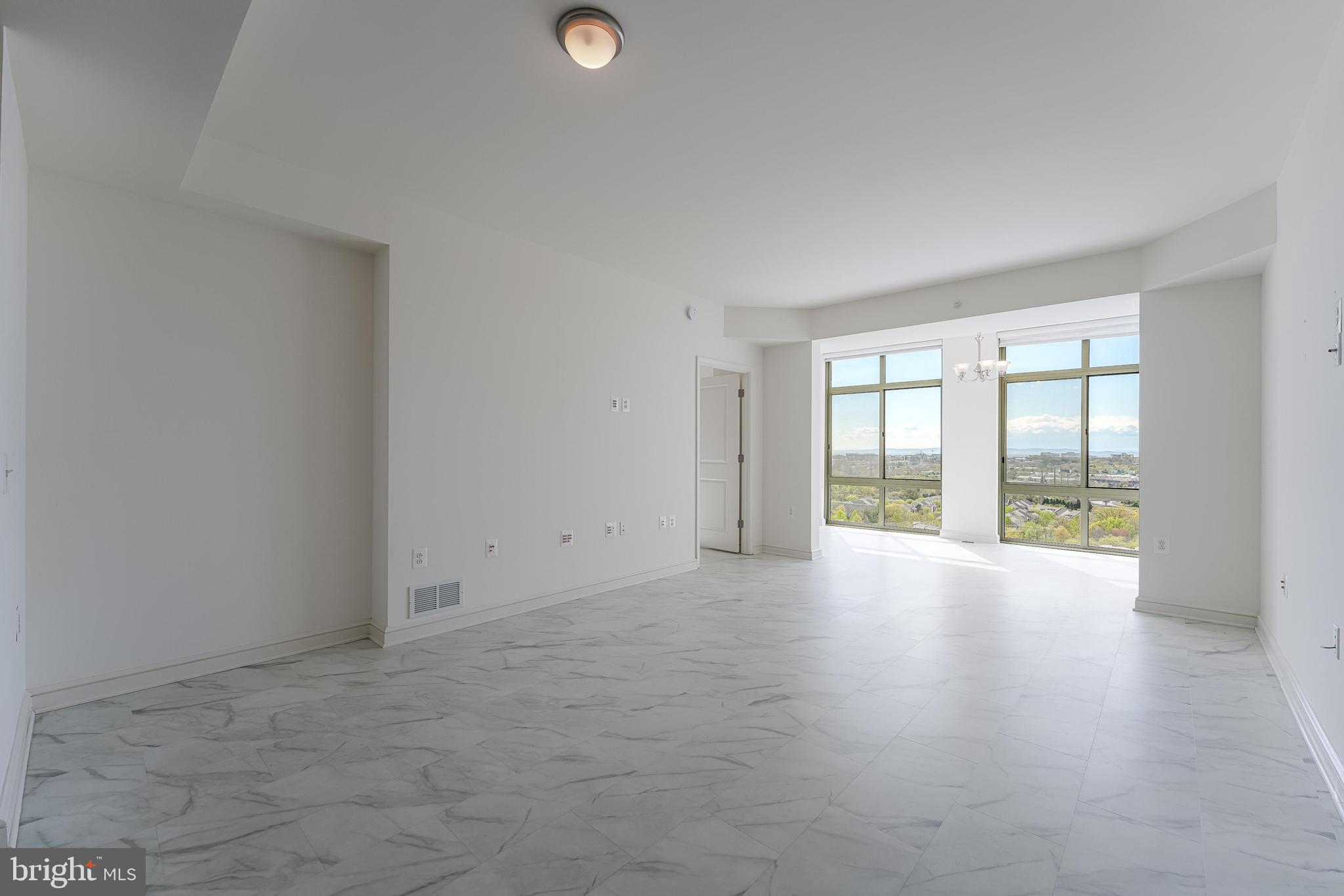 11990 Market Street, Unit 1414 Reston, VA 20190 - Photo 4 of 65 a view of an empty room with a window