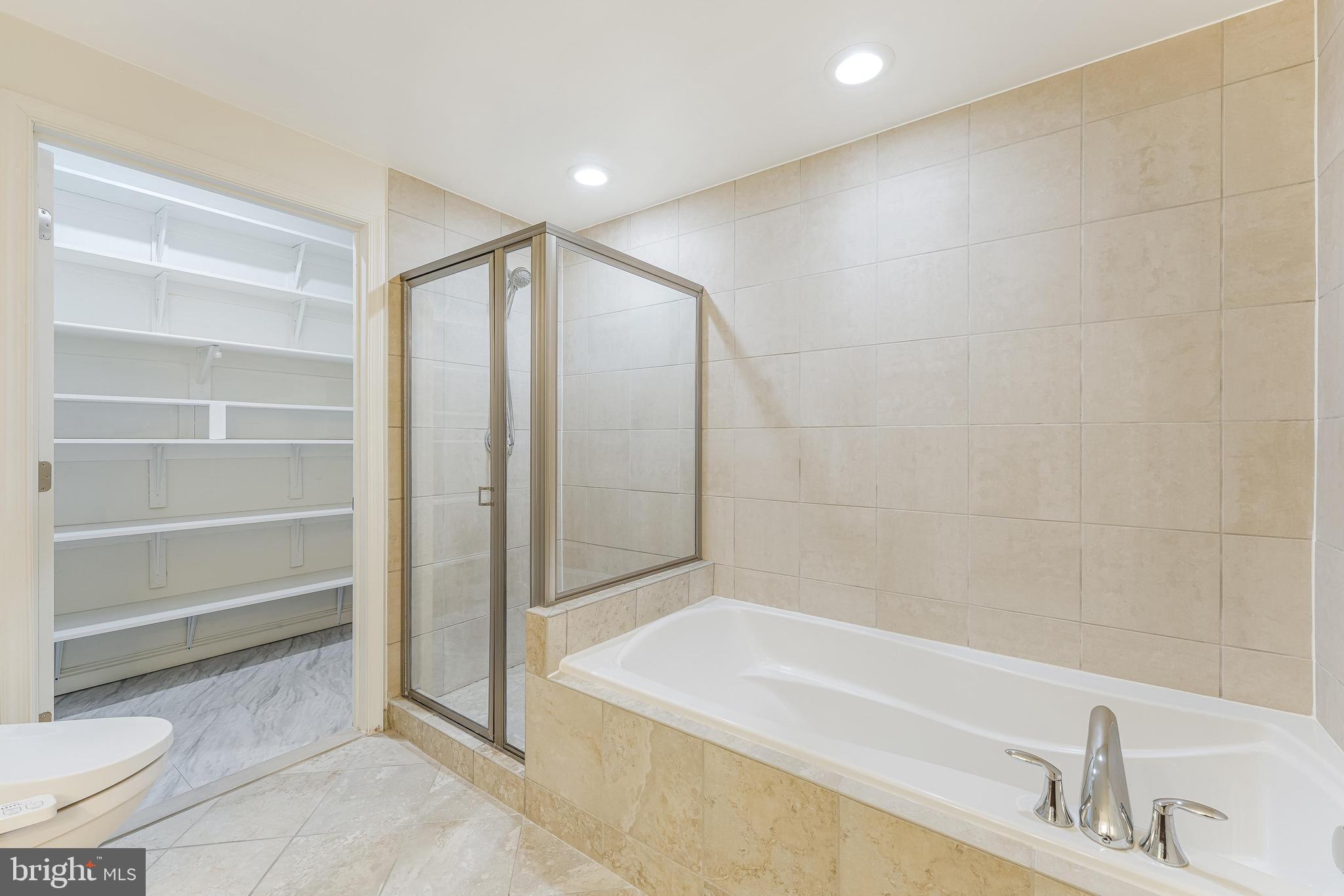 11990 Market Street, Unit 1414 Reston, VA 20190 - Photo 42 of 65 a bathroom with a bathtub and a sink