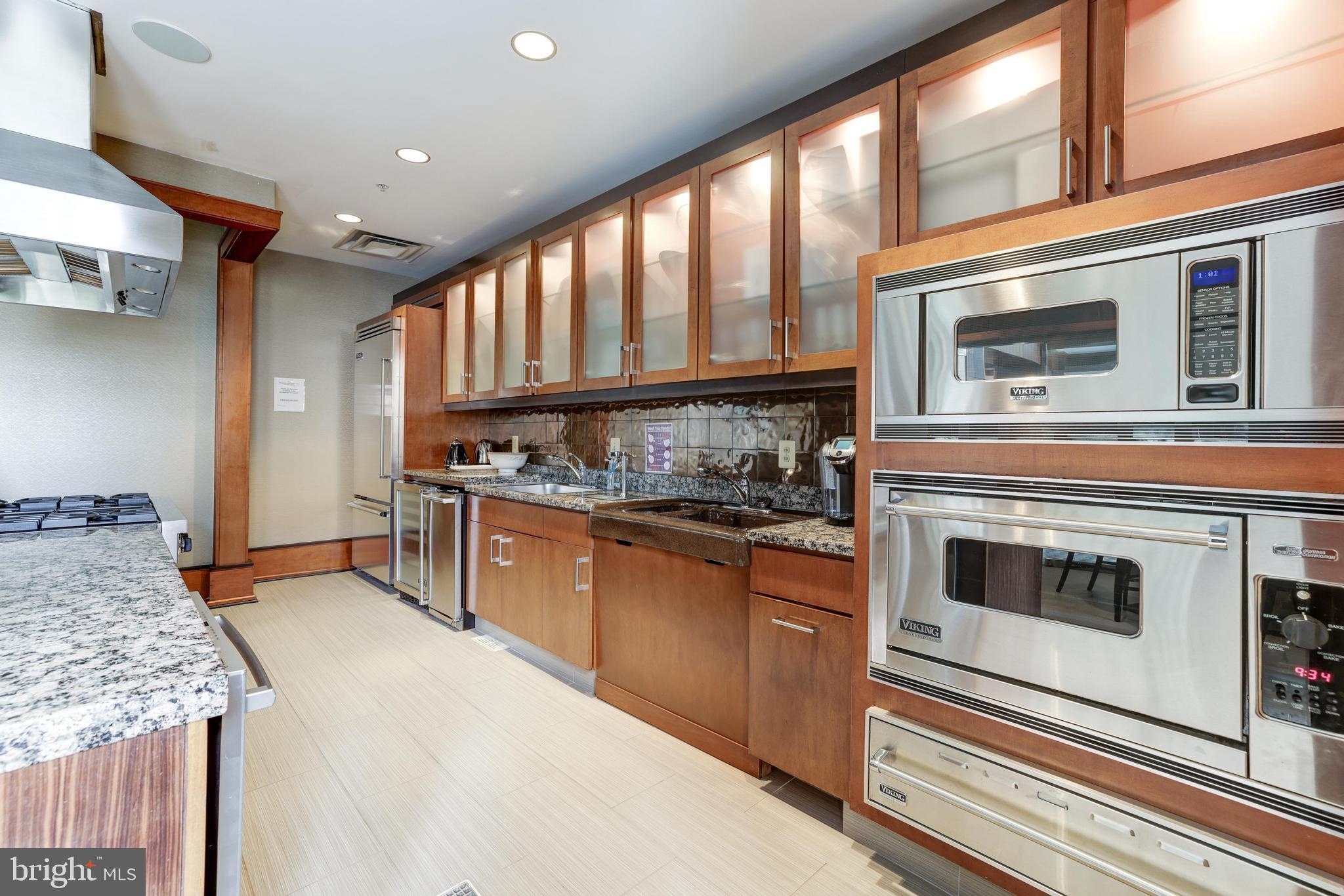 11990 Market Street, Unit 1414 Reston, VA 20190 - Photo 47 of 65 a kitchen with a stove and a microwave